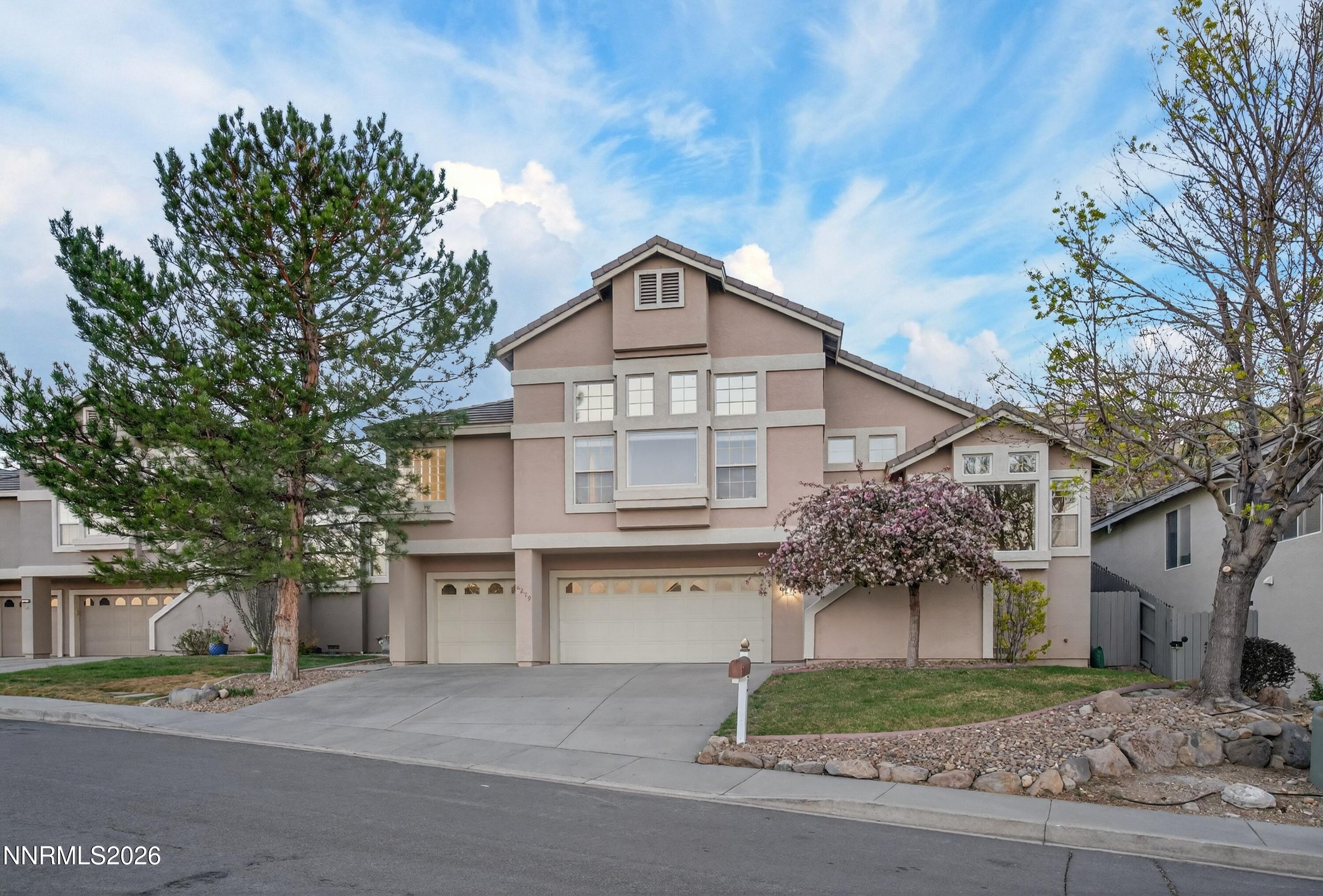 6279 Golden Meadow Road Reno, NV 89519 - Photo 1 of 57 a front view of a house with a yard and garage