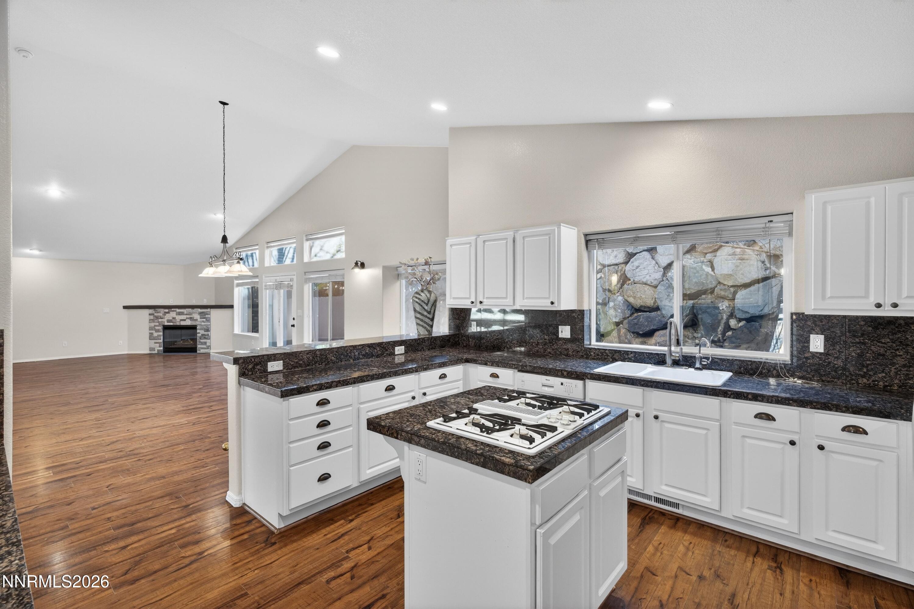 6279 Golden Meadow Road Reno, NV 89519 - Photo 16 of 57 a kitchen with a stove a sink a refrigerator and wooden cabinets