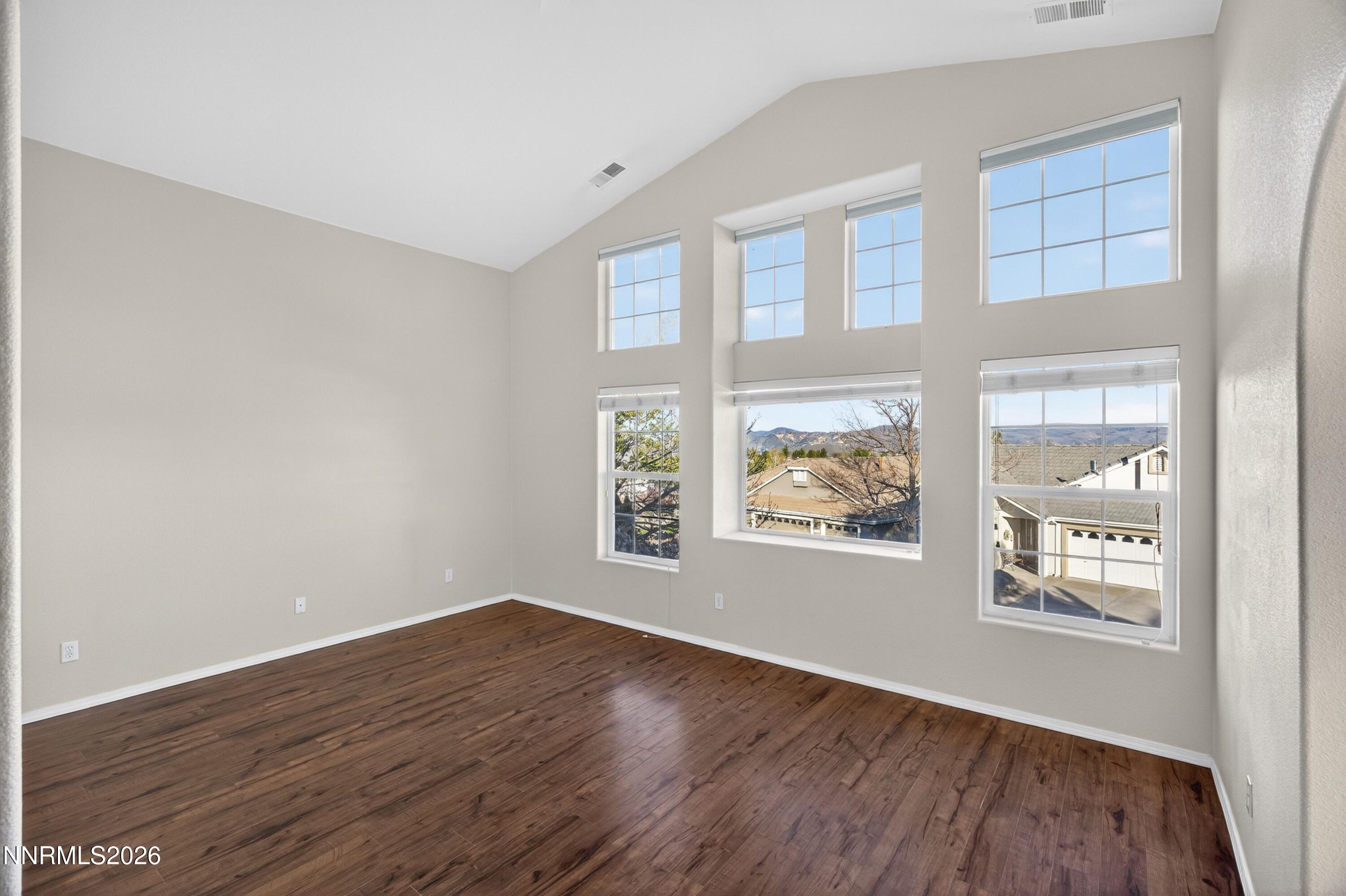 6279 Golden Meadow Road Reno, NV 89519 - Photo 27 of 57 an empty room with wooden floor and windows