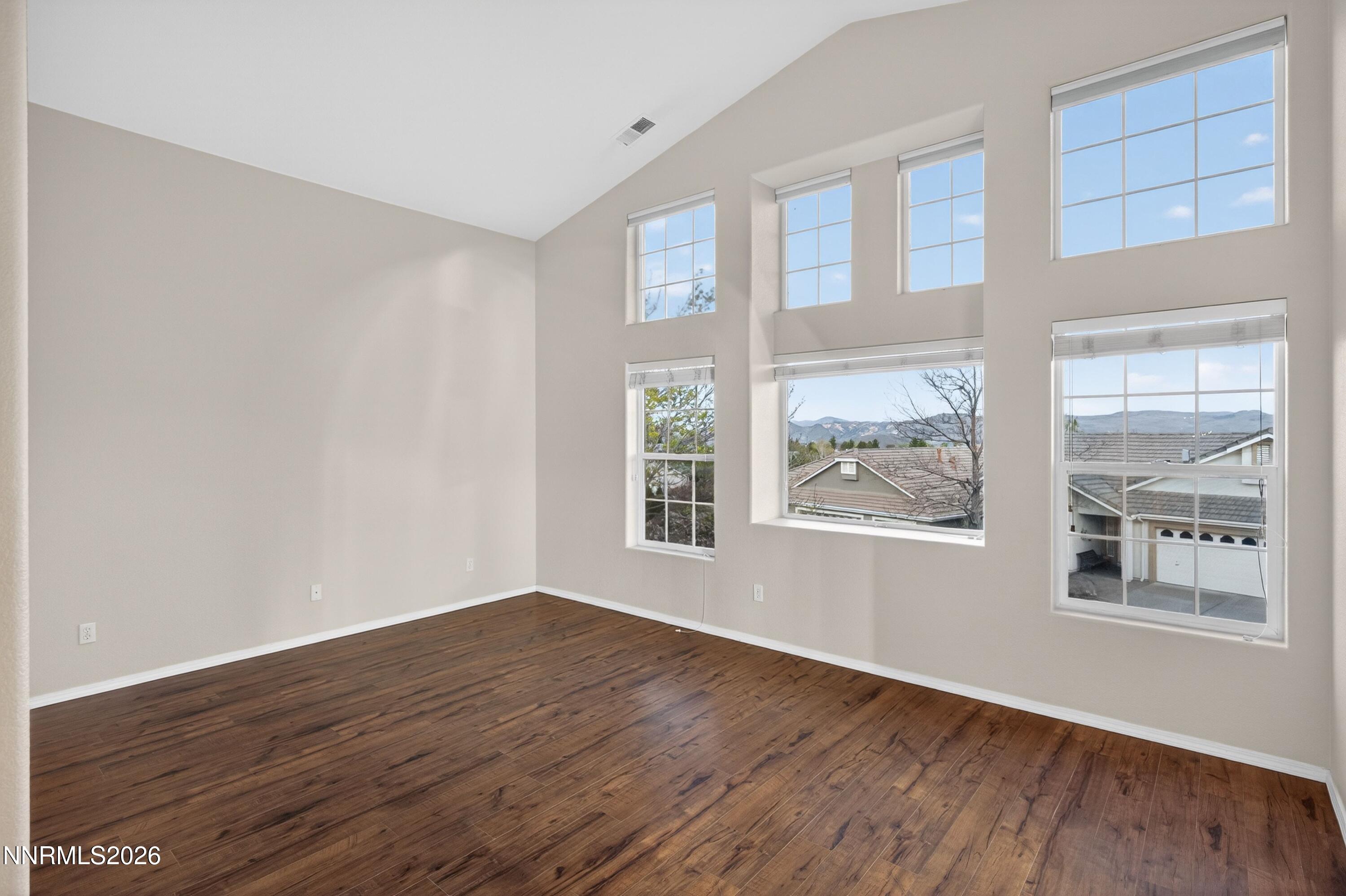 6279 Golden Meadow Road Reno, NV 89519 - Photo 29 of 57 a view of an empty room with wooden floor and a window
