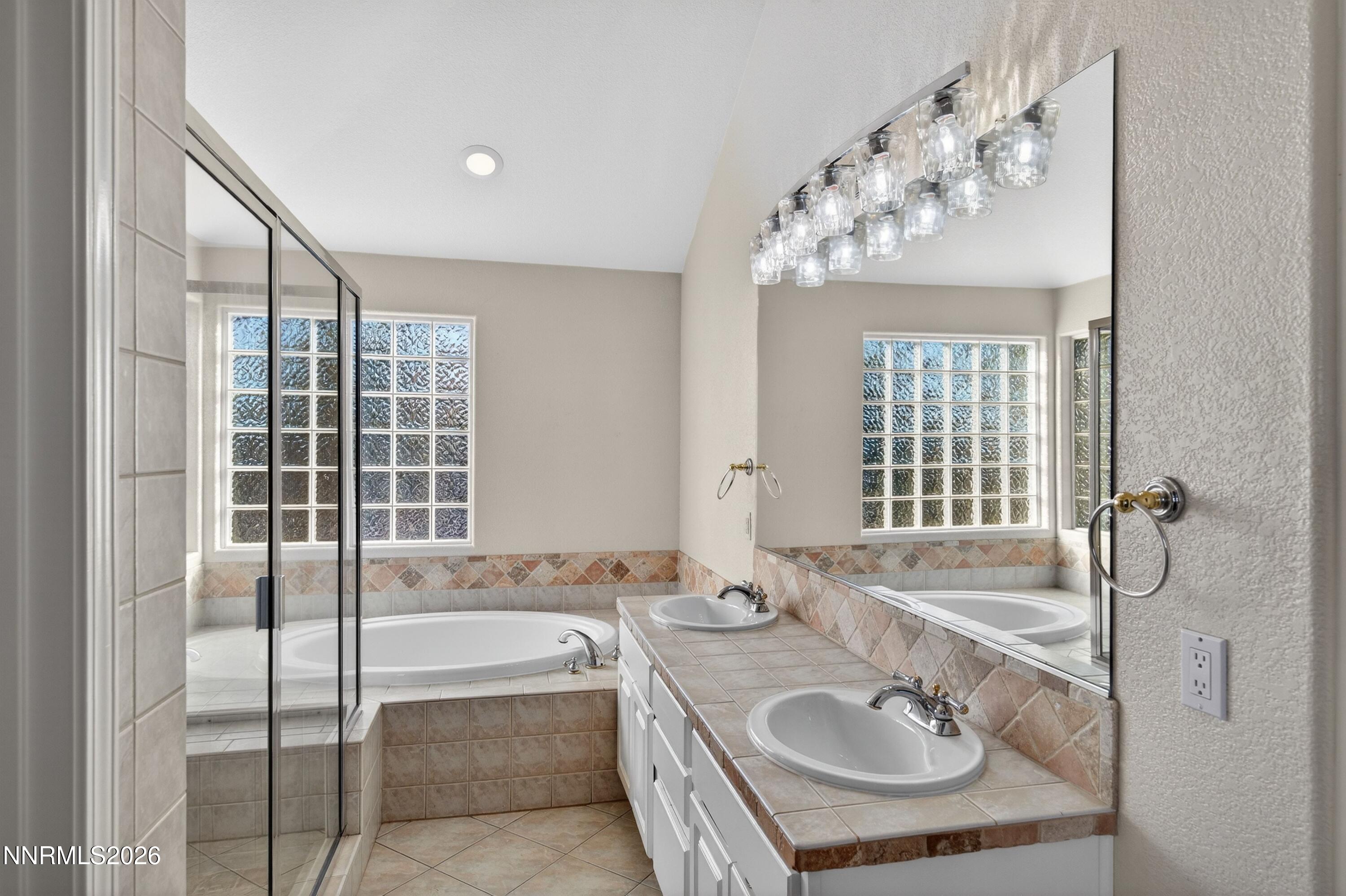 6279 Golden Meadow Road Reno, NV 89519 - Photo 33 of 57 a bathroom with a tub sink and mirror
