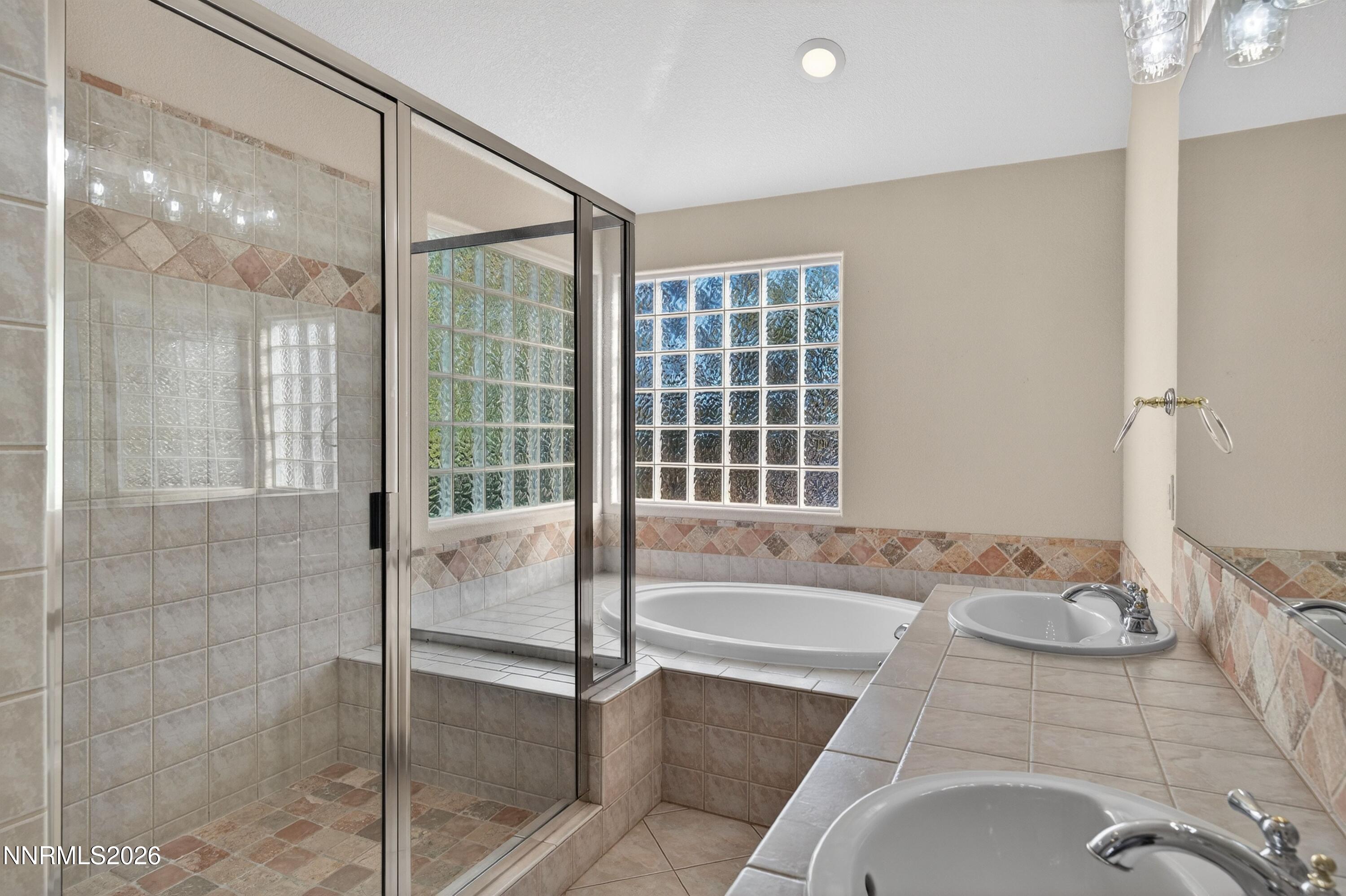 6279 Golden Meadow Road Reno, NV 89519 - Photo 34 of 57 a bathroom with a tub sink and shower