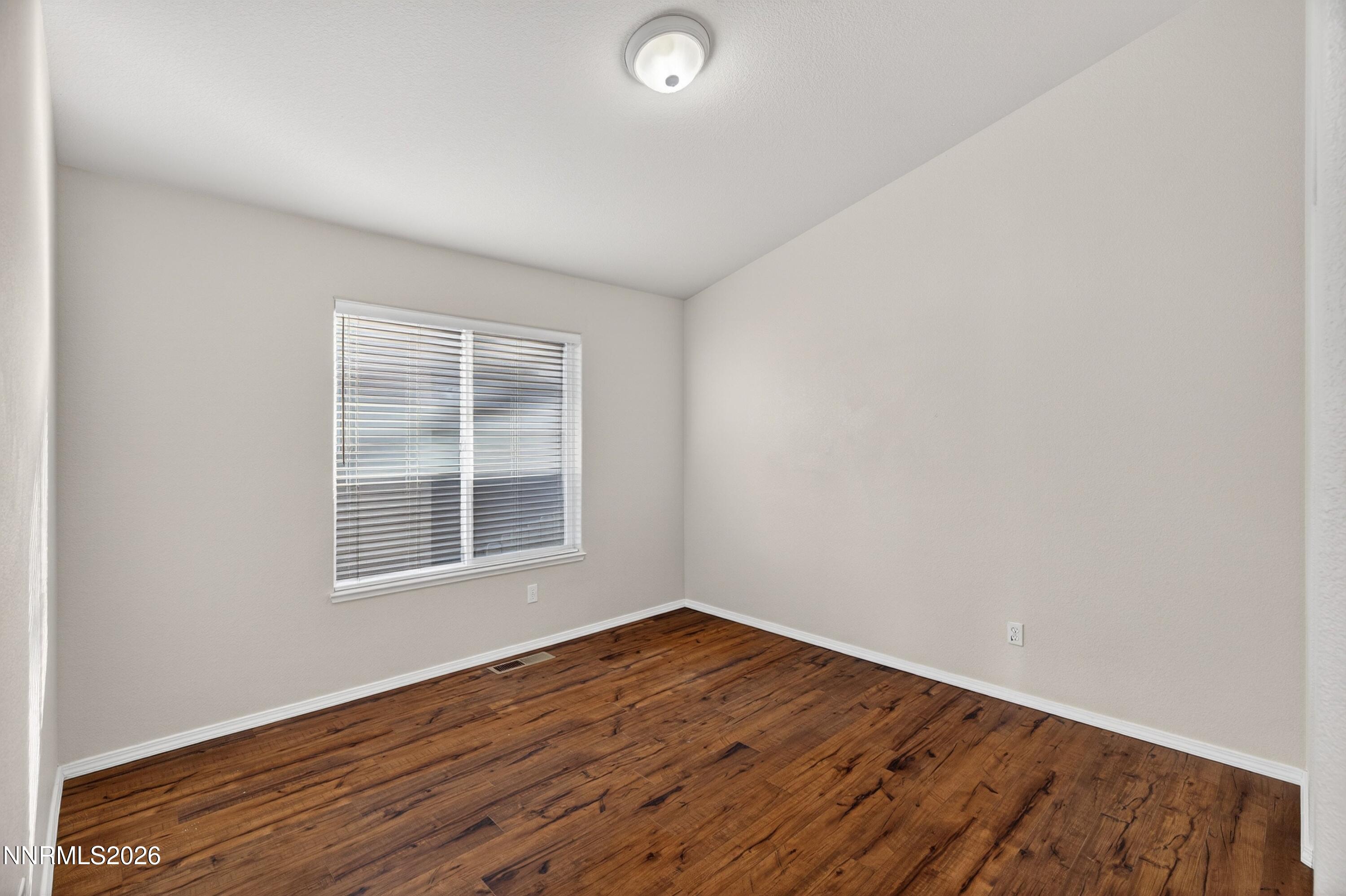 6279 Golden Meadow Road Reno, NV 89519 - Photo 36 of 57 an empty room with wooden floor and windows