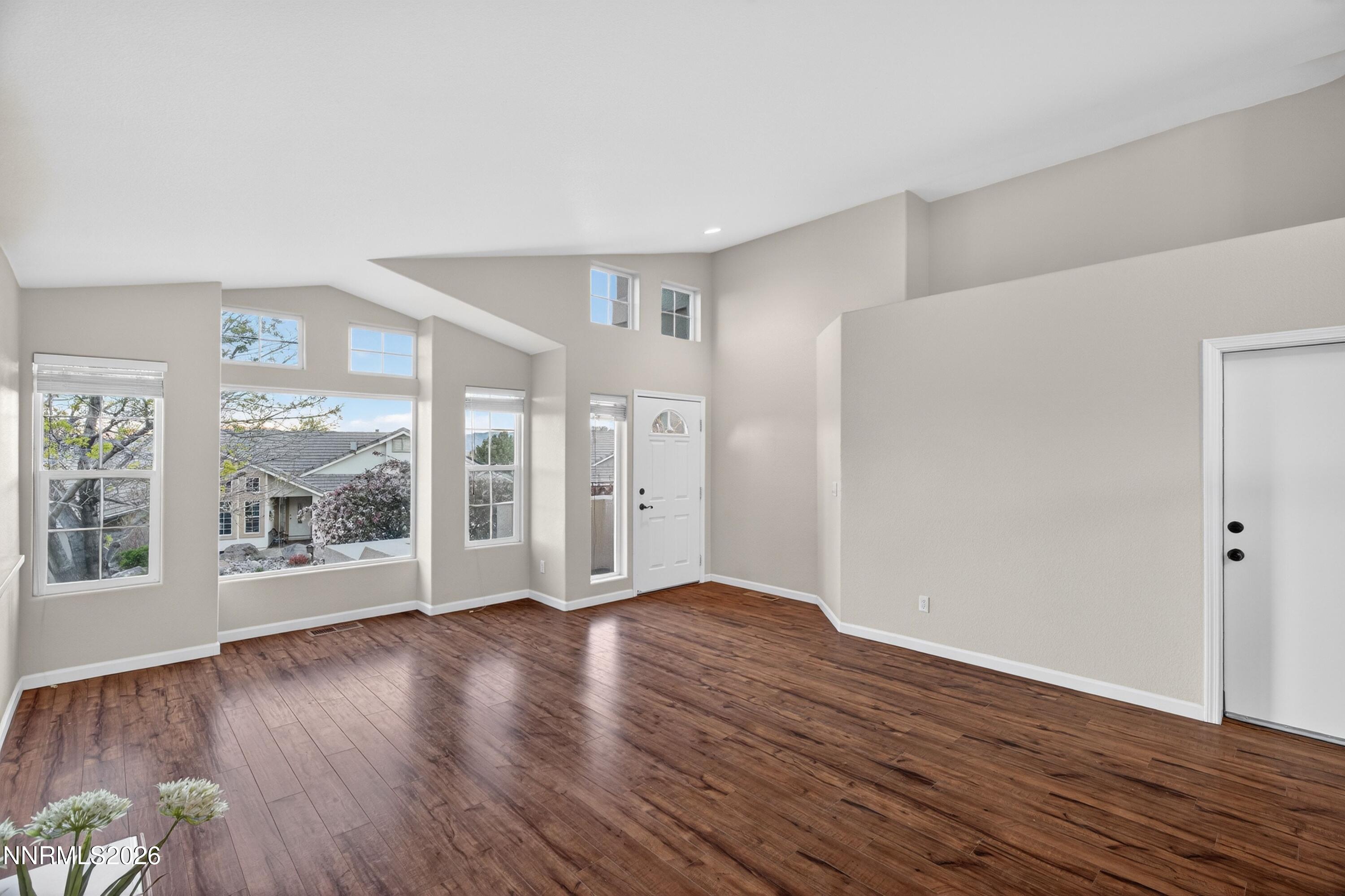 6279 Golden Meadow Road Reno, NV 89519 - Photo 6 of 57 a view of an empty room with wooden floor and a window
