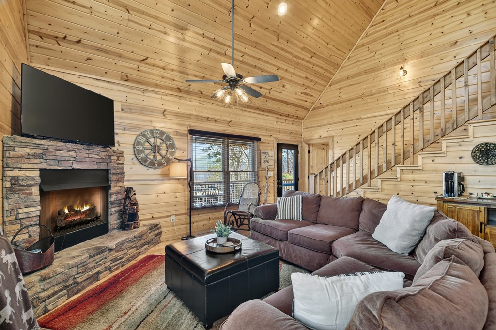 78 Brass Hill Road Blue Ridge, GA 30513 - Photo 11 of 44 a living room with furniture a fireplace and a flat screen tv