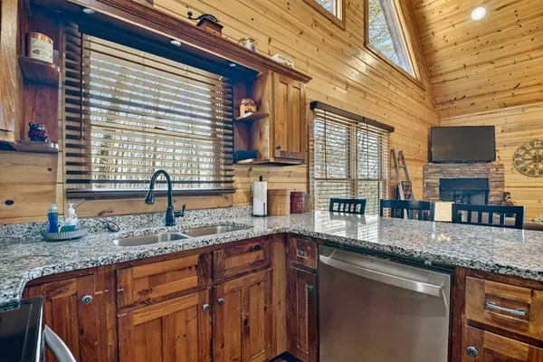 a kitchen with granite countertop a sink and a window