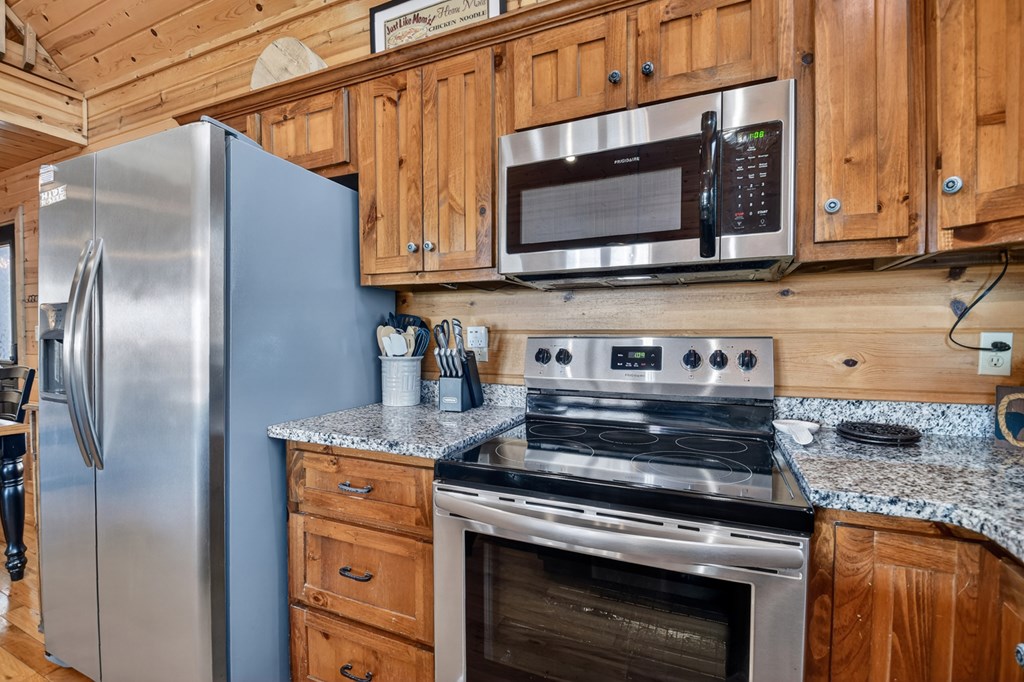 78 Brass Hill Road Blue Ridge, GA 30513 - Photo 17 of 44 a kitchen with stainless steel appliances granite countertop a stove a microwave and cabinets