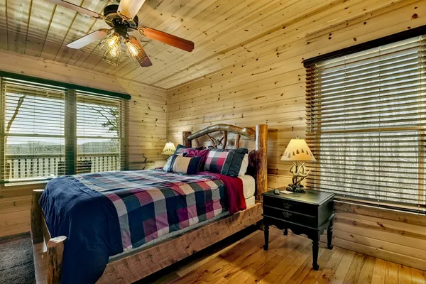 a bedroom with a bed and a chandelier