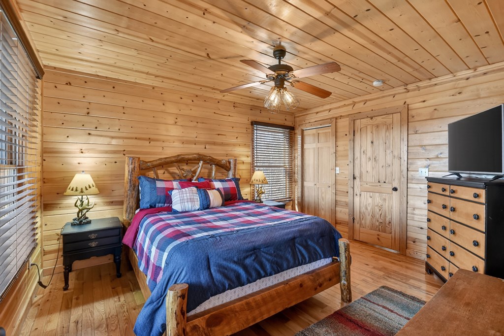 78 Brass Hill Road Blue Ridge, GA 30513 - Photo 21 of 44 a bedroom with a bed and a flat screen tv