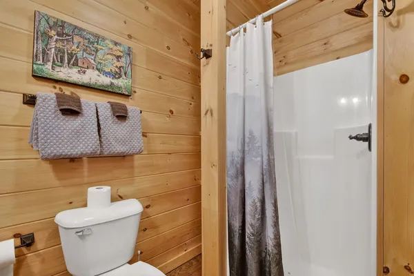 a bathroom with a toilet and a shower