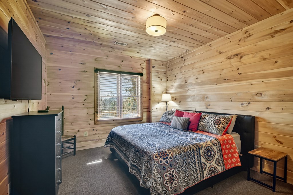 78 Brass Hill Road Blue Ridge, GA 30513 - Photo 40 of 44 a bedroom with a bed and a flat screen tv