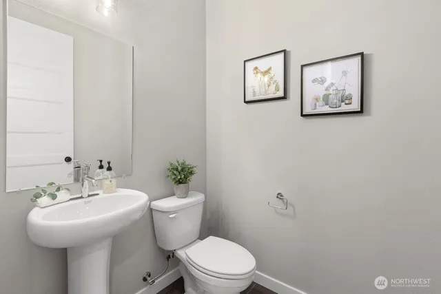 a bathroom with a sink mirror and toilet