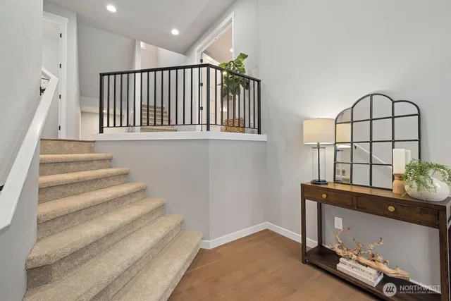 a view of entryway and hall with wooden floor