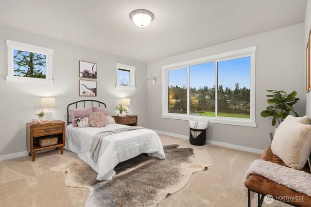 a bedroom with a large bed and a large window