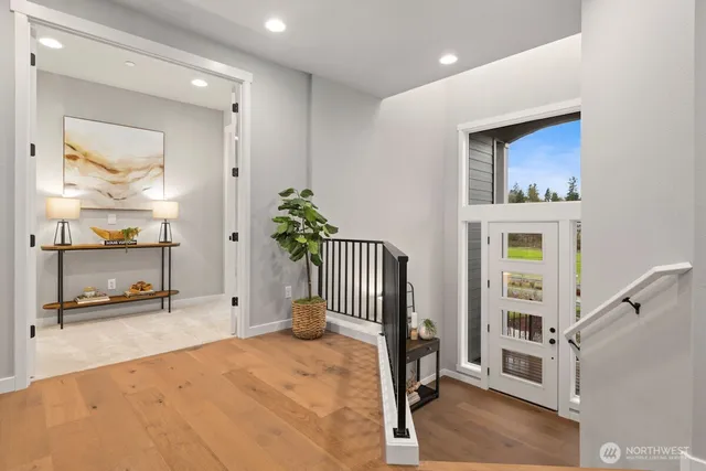 a view of an entryway with wooden floor