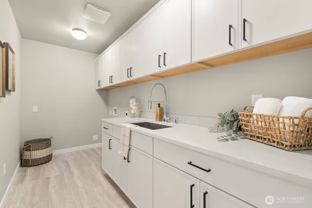 a kitchen with a sink and cabinets