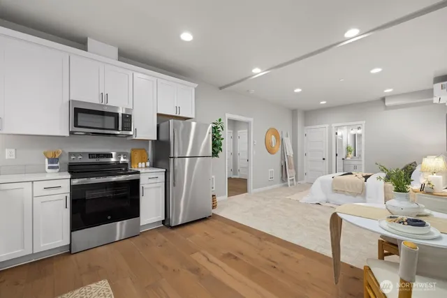 a kitchen with stainless steel appliances granite countertop a refrigerator stove microwave and sink