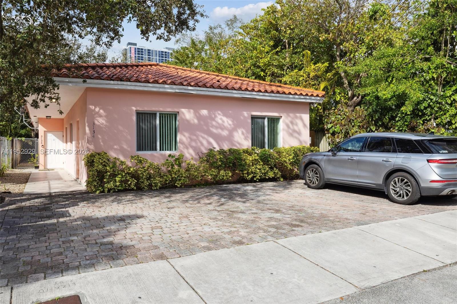 a view of a car parked in front of a house