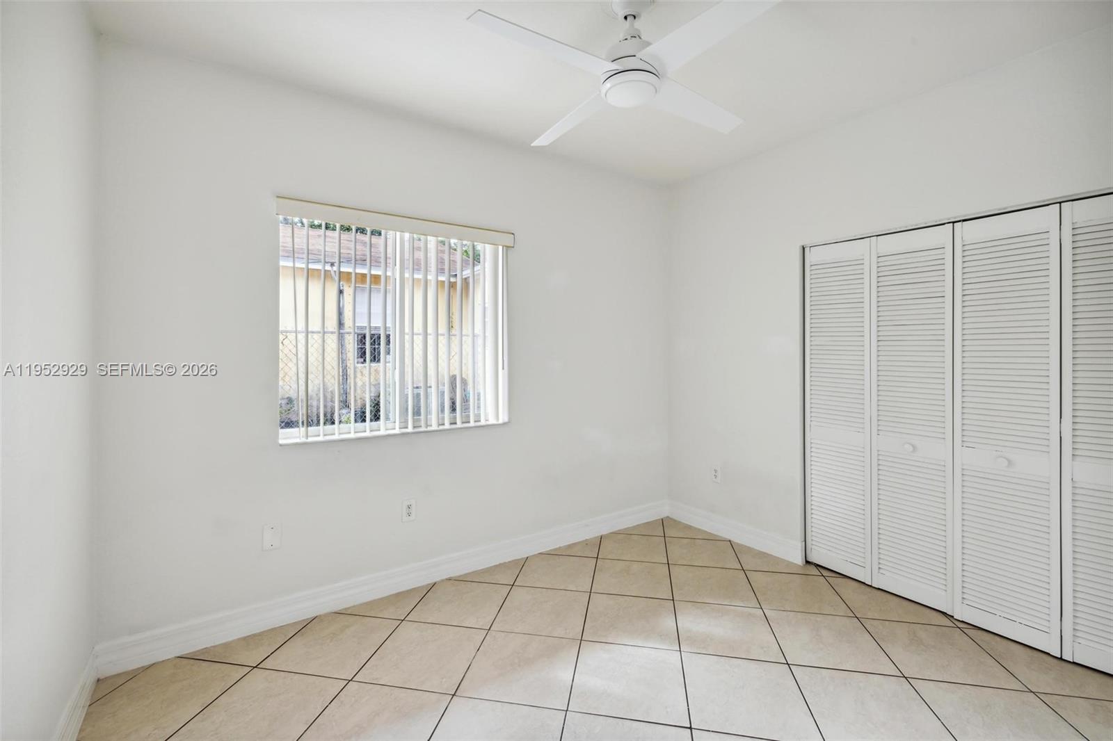3134 Hibiscus Street, Unit 3134 Miami, FL 33133 - Photo 2 of 21 a view of an empty room with window and chandelier fan