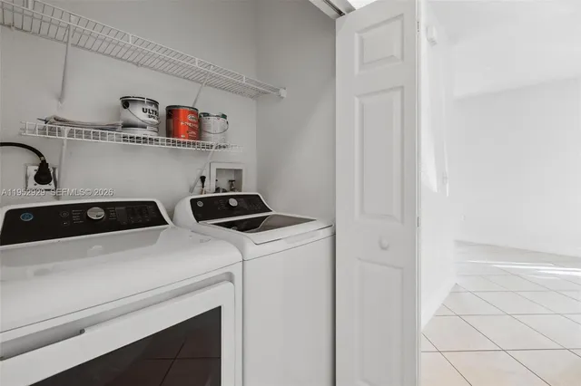 a view of storage and utility room with washer and dryer