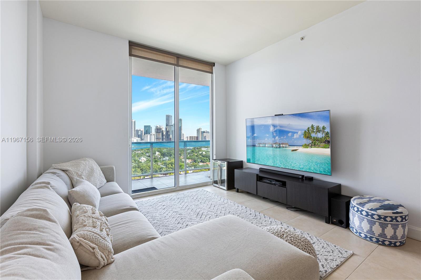 2525 Southwest 3rd Avenue, Unit 1708 Miami, FL 33129 - Photo 21 of 26 a living room with furniture tv and large window