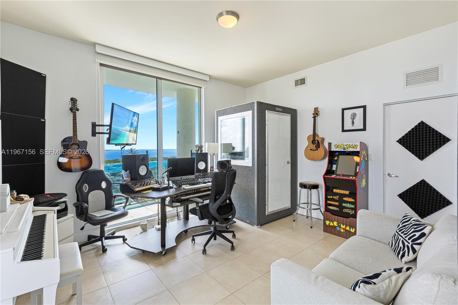 2525 Southwest 3rd Avenue, Unit 1708 Miami, FL 33129 - Photo 6 of 26 a living room with furniture and a flat screen tv
