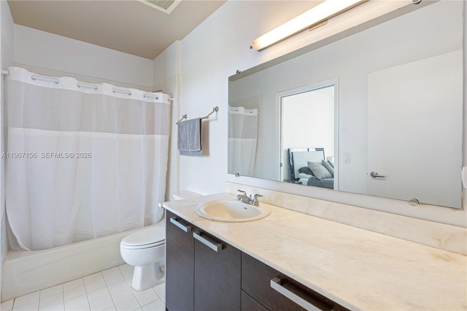 2525 Southwest 3rd Avenue, Unit 1708 Miami, FL 33129 - Photo 8 of 26 a bathroom with a sink a toilet and shower