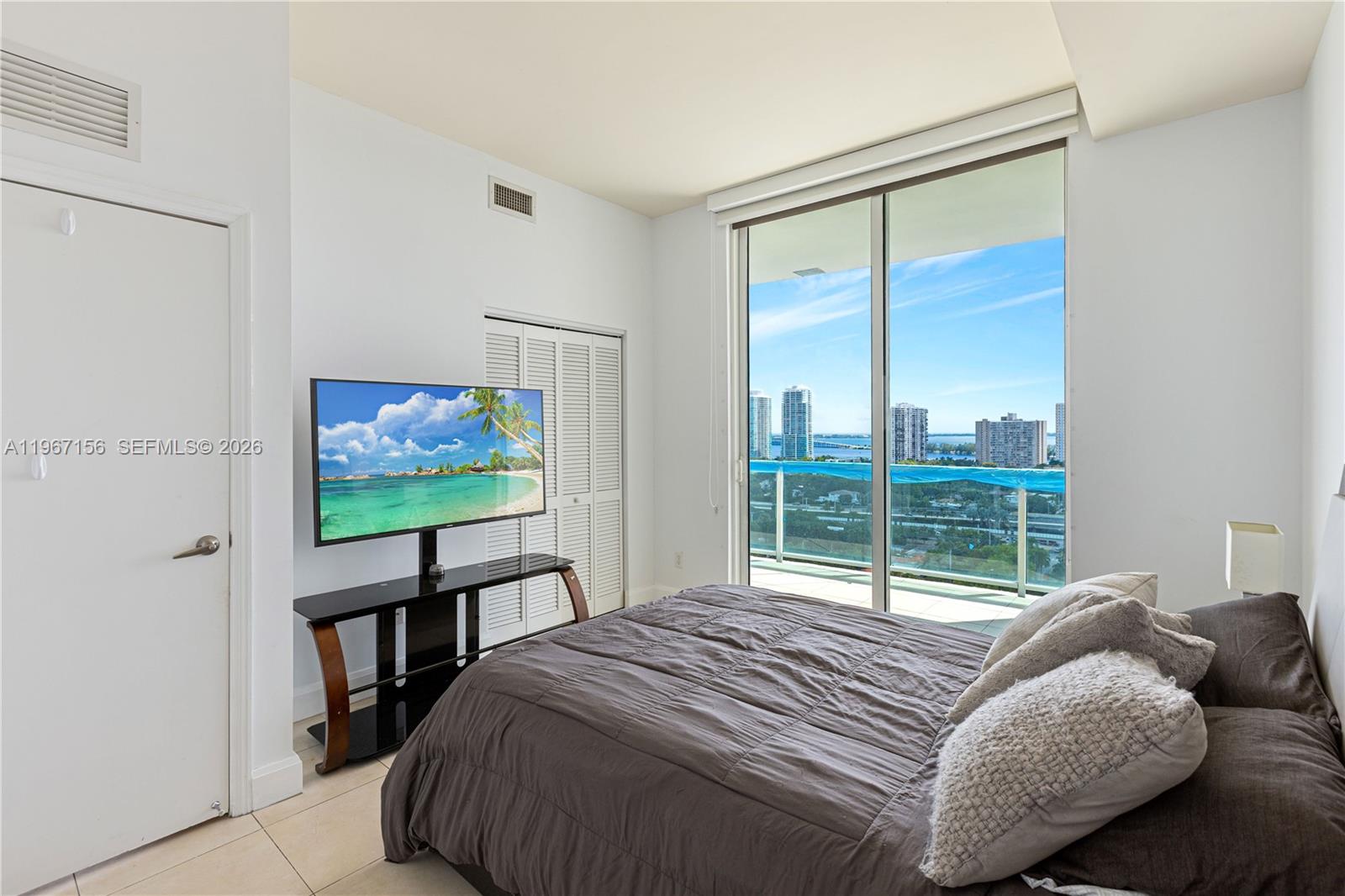 2525 Southwest 3rd Avenue, Unit 1708 Miami, FL 33129 - Photo 10 of 26 a bedroom with a bed and a flat screen tv