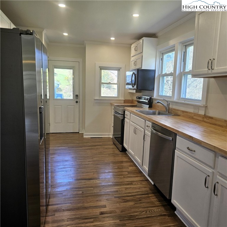 254 Green Street Boone, NC 28607 - Photo 13 of 48 a kitchen with stainless steel appliances granite countertop a refrigerator a sink dishwasher a stove and white countertops with wooden floor