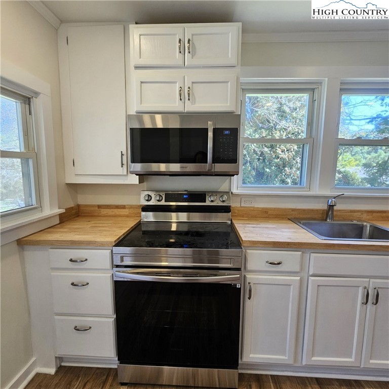 254 Green Street Boone, NC 28607 - Photo 9 of 48 a kitchen with white cabinets and appliances