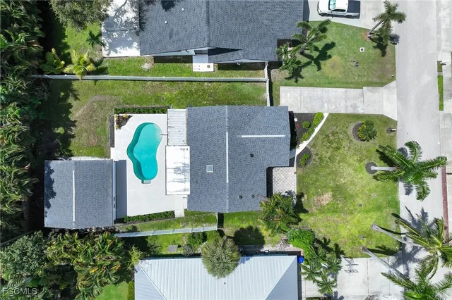 an aerial view of a house with a garden and a car park
