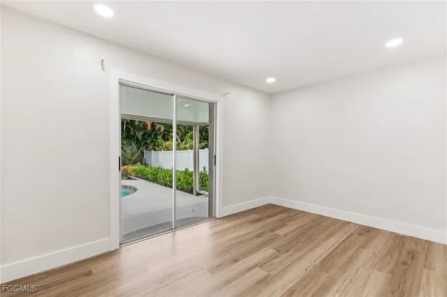 a view of a room with wooden floor and window