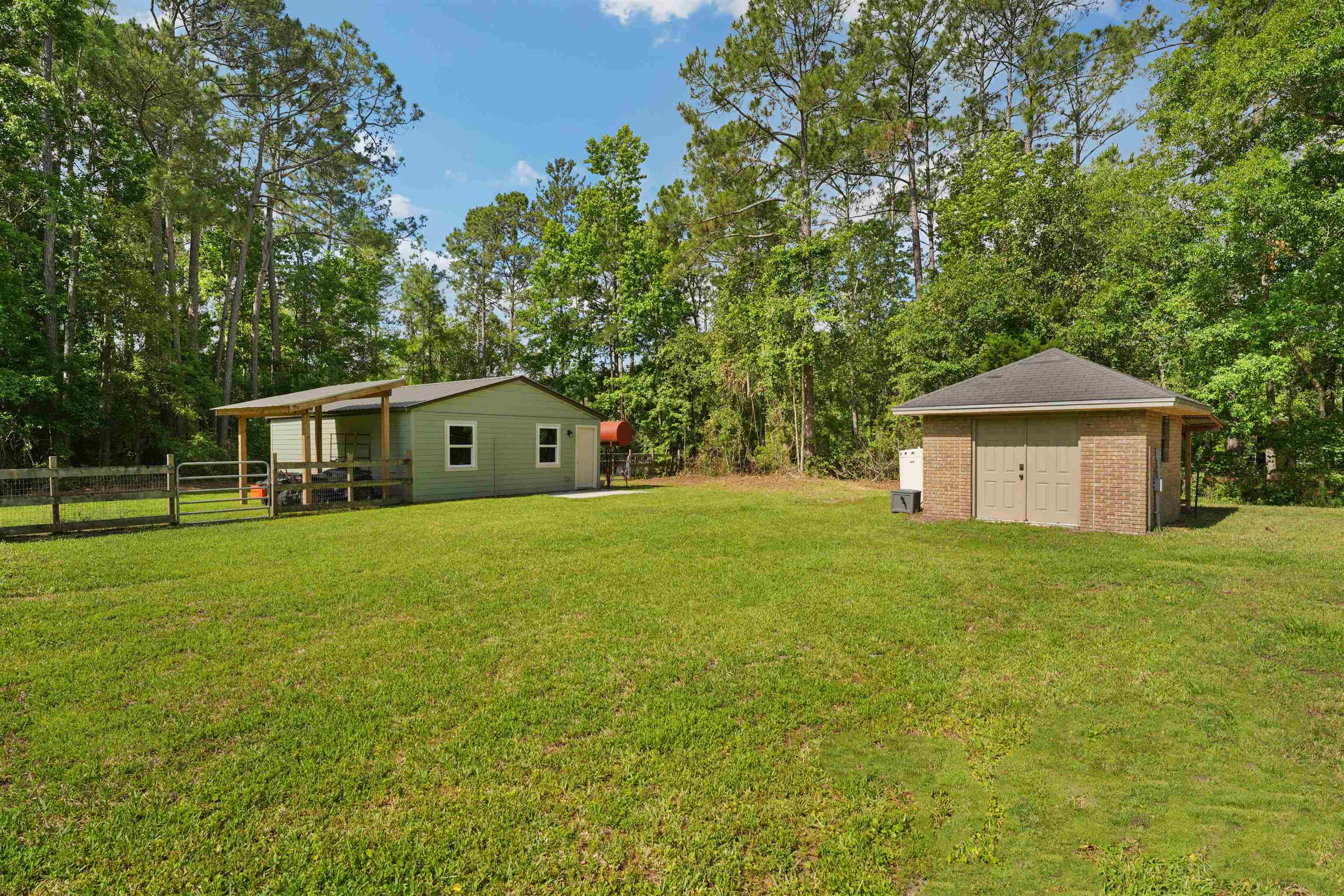 1805 Bennett Road St. Augustine, FL 32092 - Photo 44 of 65 a front view of a house with a yard and trees