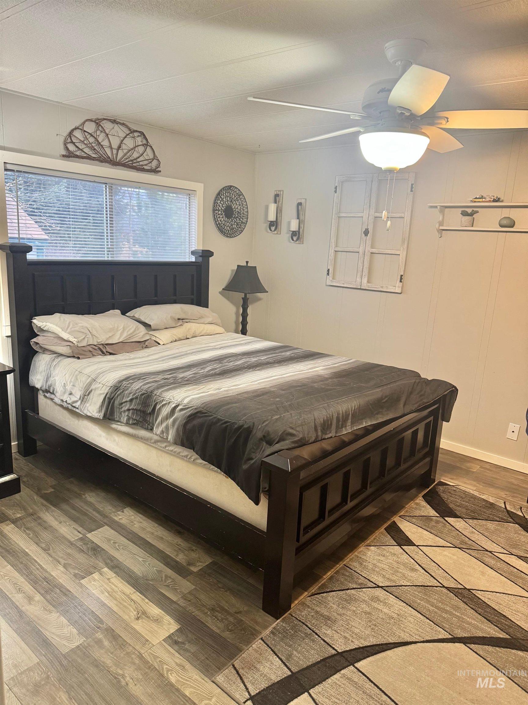 3181 West Alpine Street, Unit 22 Boise, ID 83705 - Photo 13 of 24 Bedroom featuring wood finished floors and ceiling fan