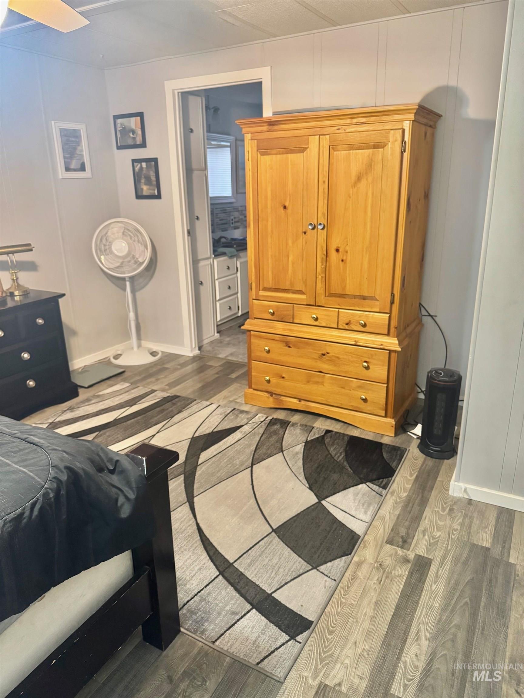 3181 West Alpine Street, Unit 22 Boise, ID 83705 - Photo 14 of 24 Bedroom with light wood-style floors and a decorative wall