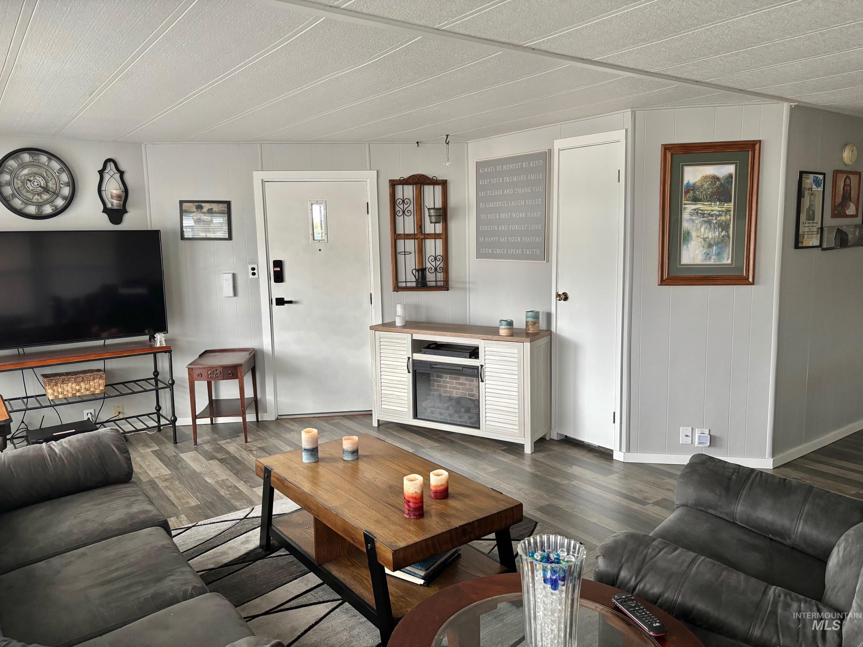 3181 West Alpine Street, Unit 22 Boise, ID 83705 - Photo 3 of 24 Living area with a fireplace and dark wood-style flooring