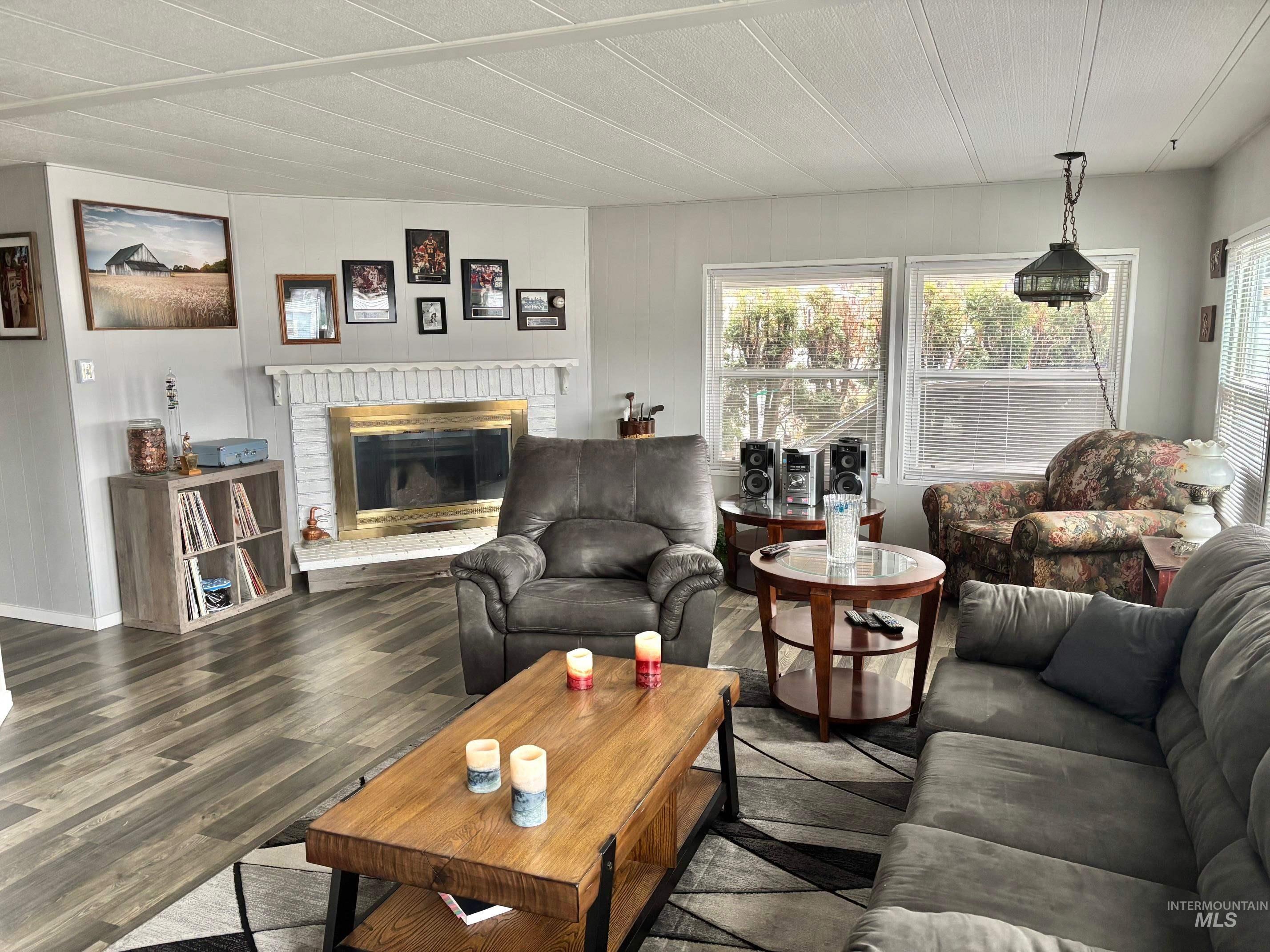 3181 West Alpine Street, Unit 22 Boise, ID 83705 - Photo 4 of 24 Living area featuring wood finished floors and a fireplace