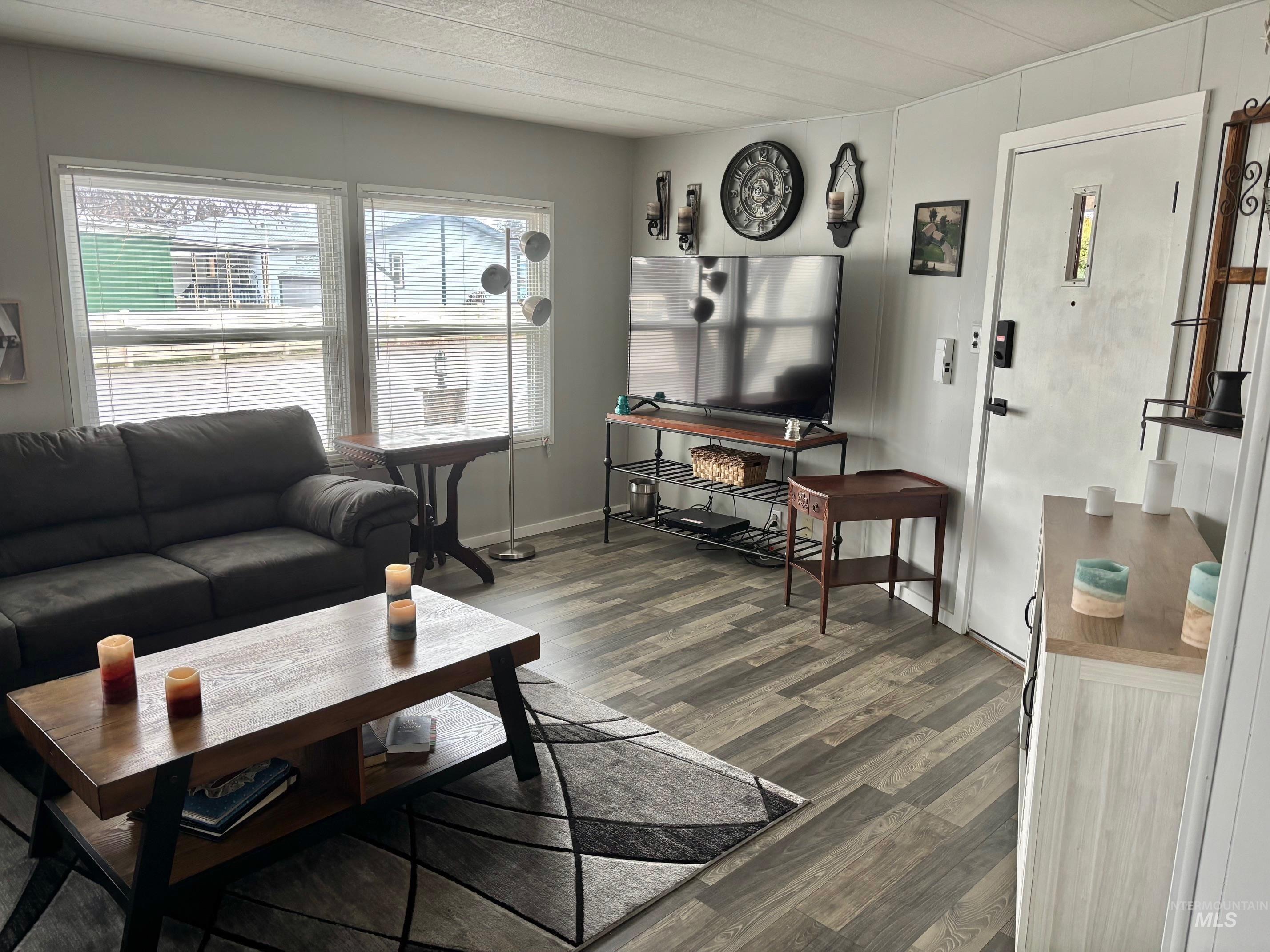 3181 West Alpine Street, Unit 22 Boise, ID 83705 - Photo 6 of 24 Living area featuring dark wood finished floors and baseboards