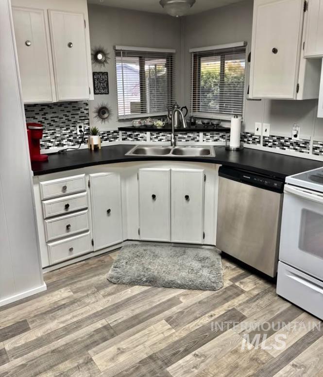3181 West Alpine Street, Unit 22 Boise, ID 83705 - Photo 7 of 24 Kitchen with white electric range, white cabinetry, stainless steel dishwasher, and decorative backsplash
