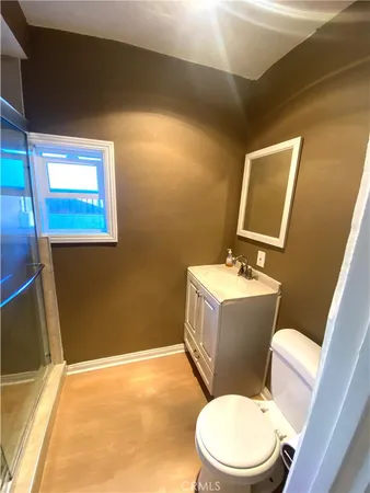 a white toilet sitting next to a bathroom sink