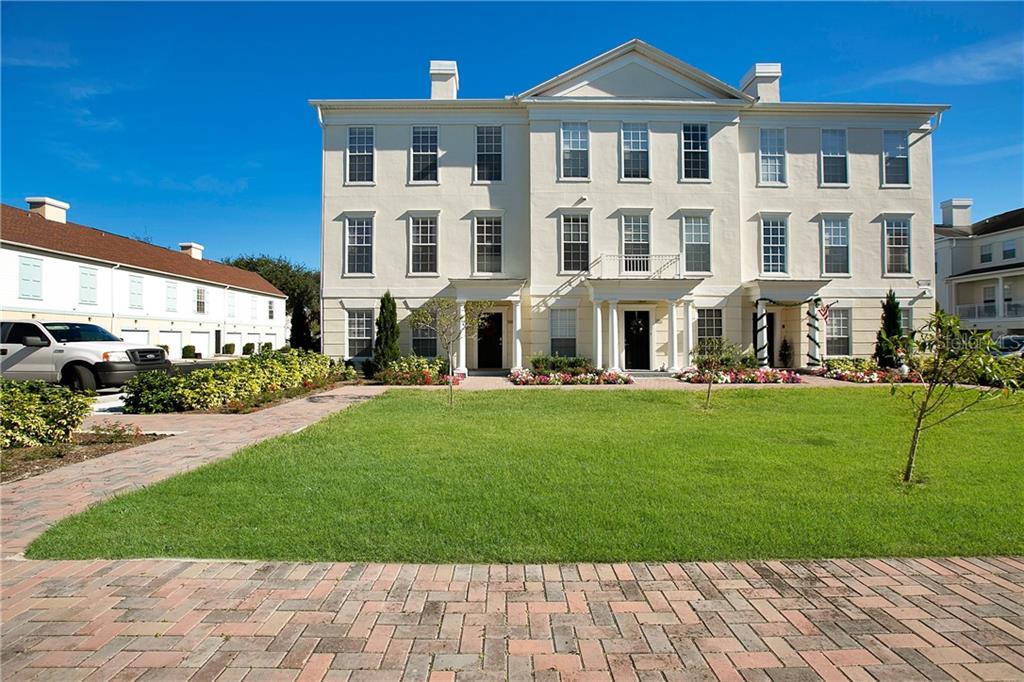 a front view of a residential apartment building with a yard