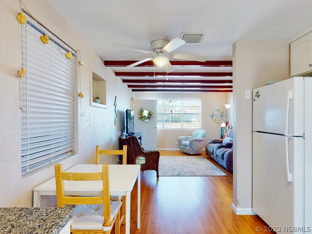37 Ocean Shore Drive Ormond Beach, FL 32176 - Photo 11 of 50 a kitchen with a refrigerator and a dining table
