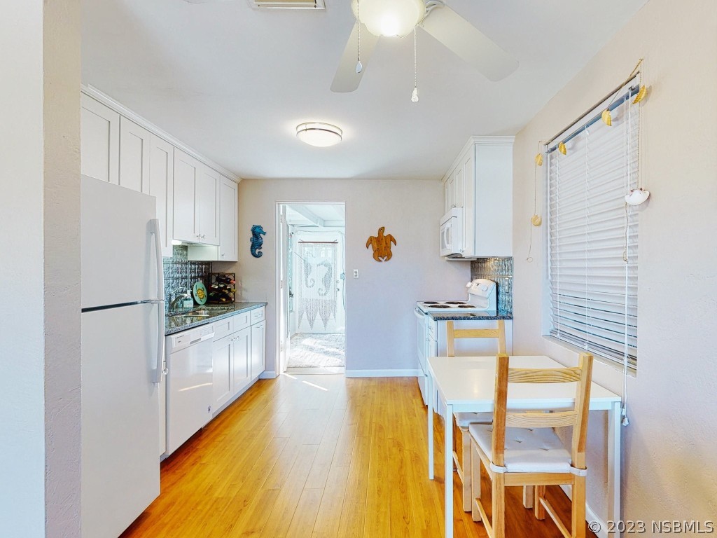 37 Ocean Shore Drive Ormond Beach, FL 32176 - Photo 13 of 50 a kitchen with stainless steel appliances granite countertop a sink refrigerator and cabinets
