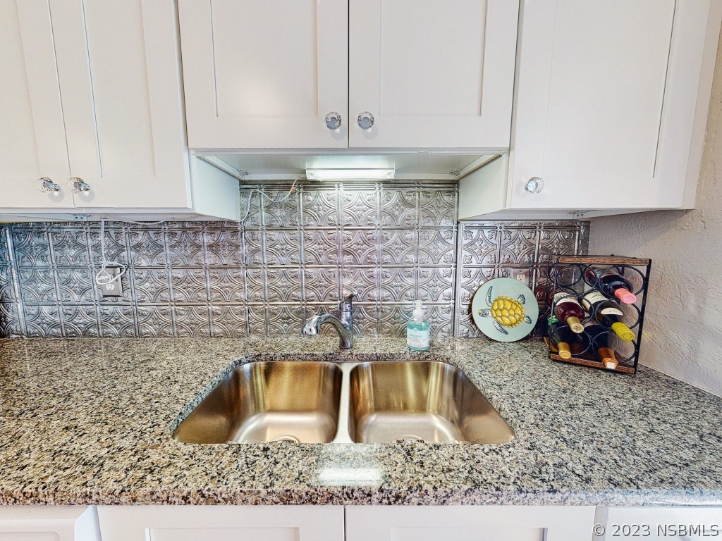 37 Ocean Shore Drive Ormond Beach, FL 32176 - Photo 15 of 50 a kitchen with a sink a stove and cabinets