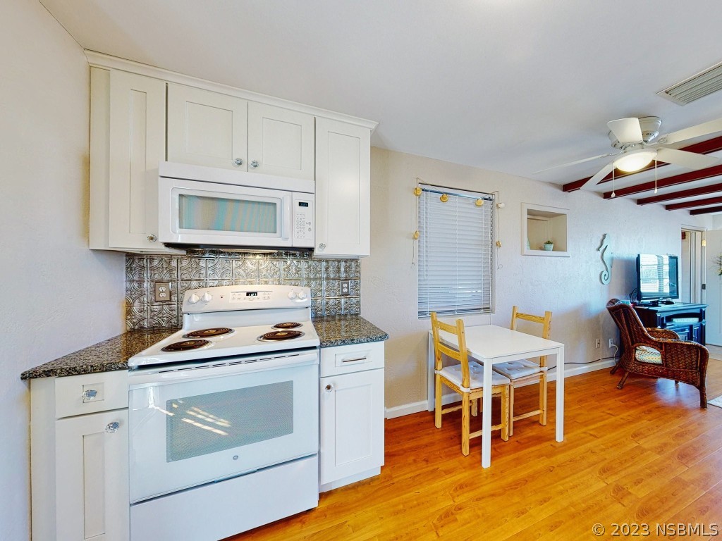 37 Ocean Shore Drive Ormond Beach, FL 32176 - Photo 16 of 50 a kitchen with a stove a sink and a refrigerator