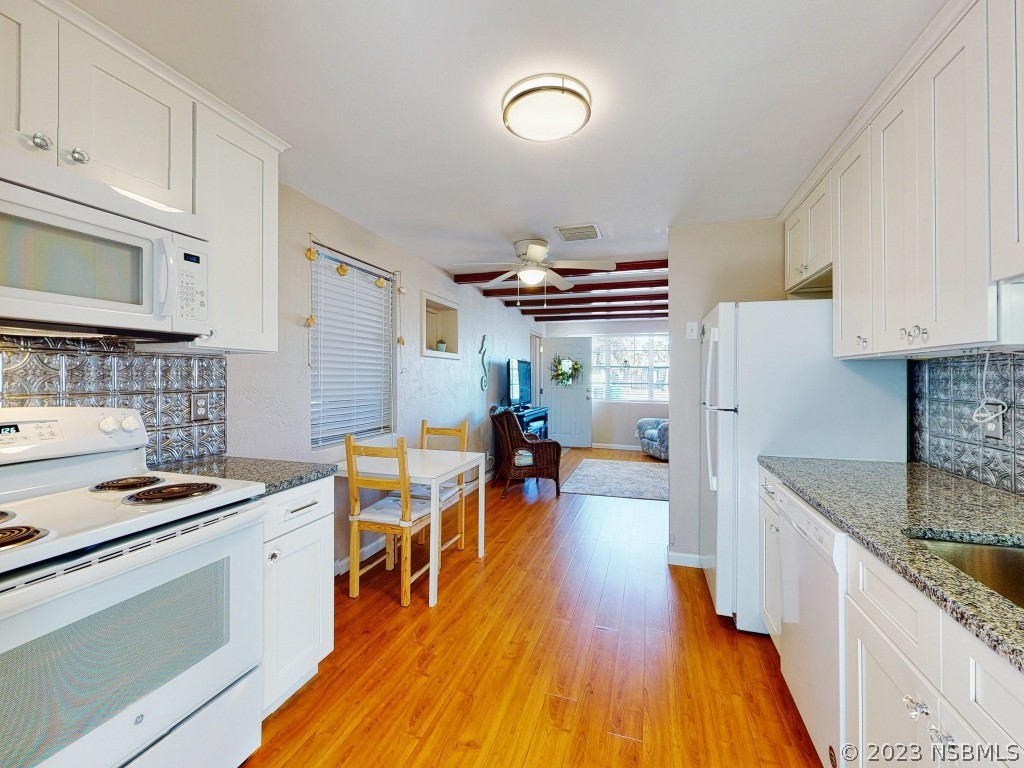 37 Ocean Shore Drive Ormond Beach, FL 32176 - Photo 17 of 50 a kitchen with stainless steel appliances a stove a sink dishwasher and a refrigerator