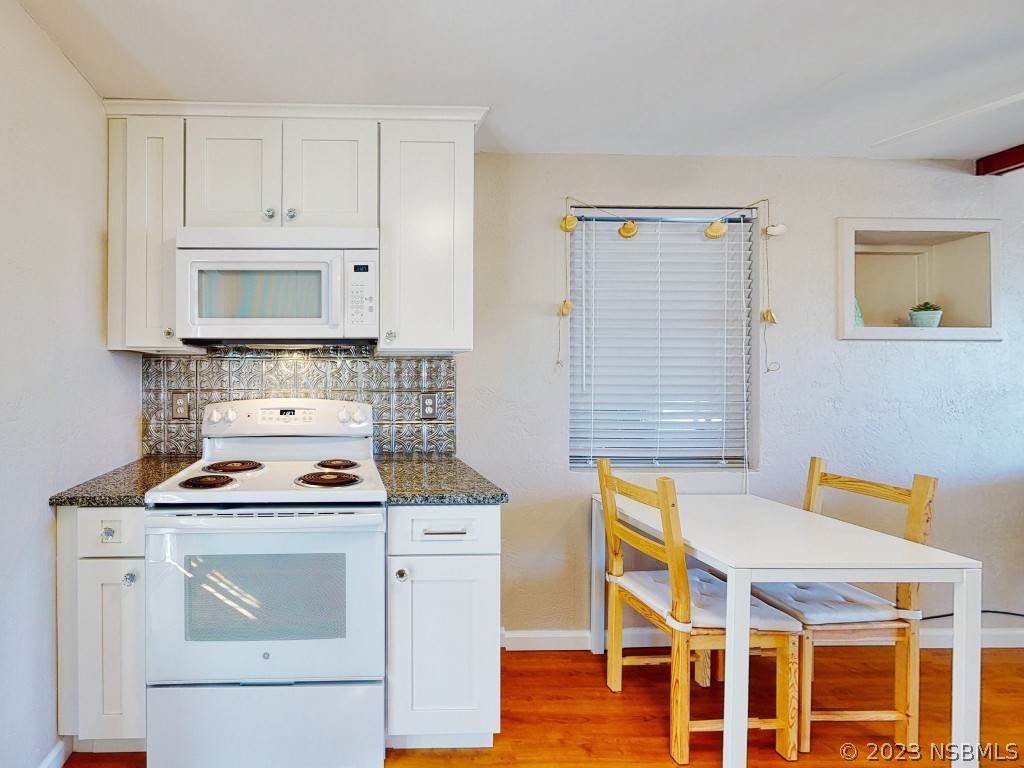 37 Ocean Shore Drive Ormond Beach, FL 32176 - Photo 18 of 50 a kitchen with stainless steel appliances a stove a white cabinet and a granite countertops with cabinets