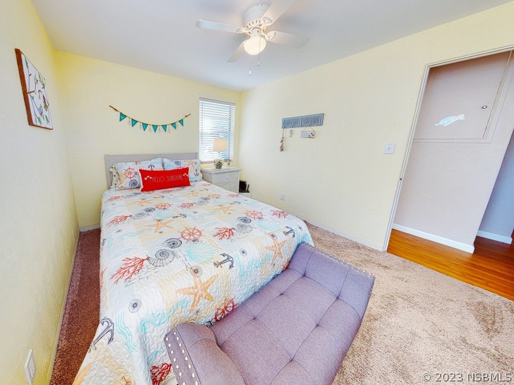 37 Ocean Shore Drive Ormond Beach, FL 32176 - Photo 21 of 50 a bedroom with a bed and a chandelier