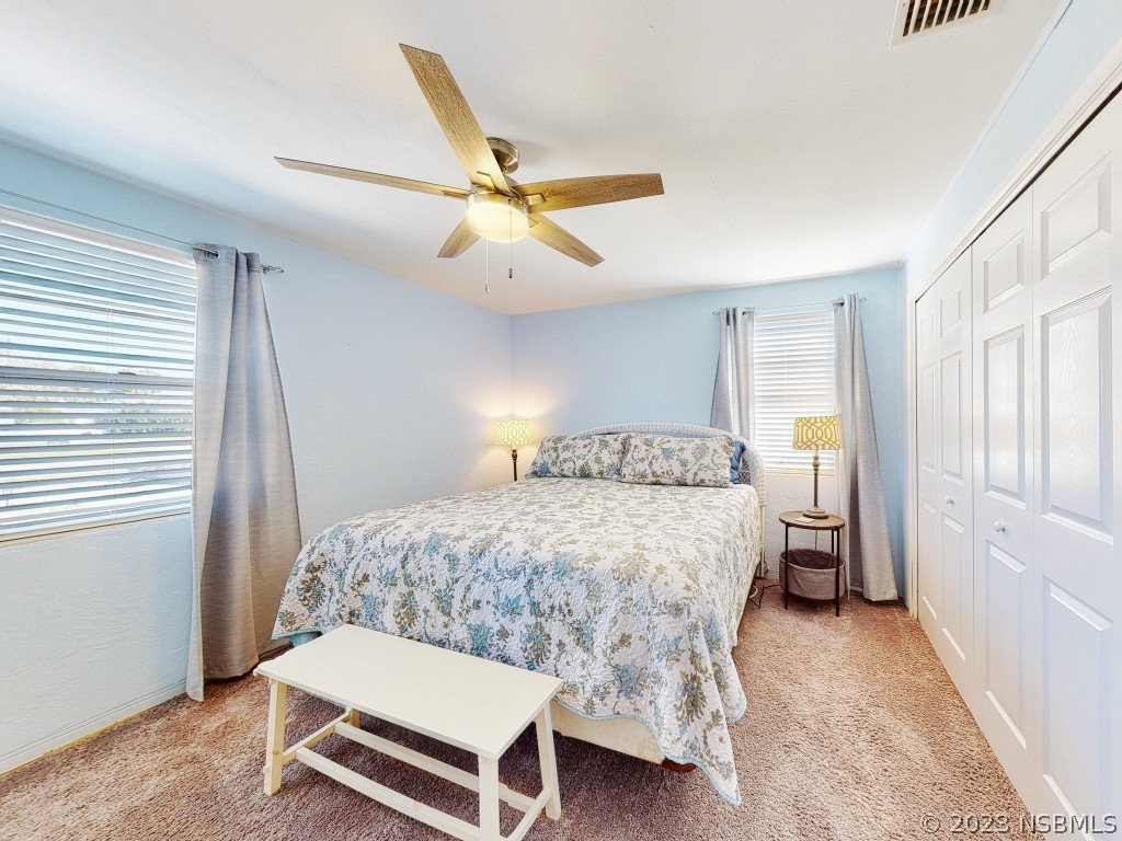 37 Ocean Shore Drive Ormond Beach, FL 32176 - Photo 23 of 50 a bedroom with a bed and a chandelier