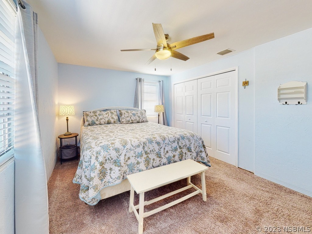 37 Ocean Shore Drive Ormond Beach, FL 32176 - Photo 24 of 50 a bedroom with a bed and a chandelier